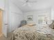 Bright bedroom with neutral carpeting, complemented by a decorative floral-patterned bedspread at 1642 Pennecamp Dr, The Villages, FL 32162