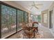 Enclosed lanai featuring tile flooring, ceiling fan, and sliding glass doors to the exterior and kitchen at 1642 Pennecamp Dr, The Villages, FL 32162