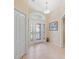 Bright foyer features a decorative glass front door and neutral tile flooring at 1642 Pennecamp Dr, The Villages, FL 32162