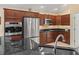 Updated kitchen featuring stainless steel appliances and rich wood cabinets at 1642 Pennecamp Dr, The Villages, FL 32162
