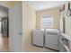 Convenient laundry room with modern washer and dryer at 1642 Pennecamp Dr, The Villages, FL 32162