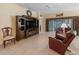 Spacious living room with tile floors, sliding glass doors, and comfortable seating at 1642 Pennecamp Dr, The Villages, FL 32162