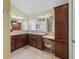 The main bathroom features double sinks, wooden cabinets, and a vanity with a chair for added convenience at 1642 Pennecamp Dr, The Villages, FL 32162