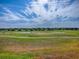 Panoramic view of the grassy backyard that overlooks a pond at 17563 Se 122Nd Ter, Summerfield, FL 34491