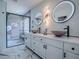Modern bathroom featuring a double sink vanity with vessel sinks, light-up mirrors, and a glass-enclosed shower at 17563 Se 122Nd Ter, Summerfield, FL 34491