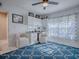 Versatile bonus room featuring built-in storage, a patterned rug, and stylish seating for flexible living at 17563 Se 122Nd Ter, Summerfield, FL 34491