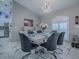 Formal dining room boasts modern light fixture, sleek table, and ample seating at 17563 Se 122Nd Ter, Summerfield, FL 34491