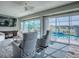 Inviting lanai featuring comfortable seating with ceiling fan and screened windows overlooking the pool at 17563 Se 122Nd Ter, Summerfield, FL 34491