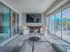 Cozy lanai with comfortable seating and glass table with a view of the pool area at 17563 Se 122Nd Ter, Summerfield, FL 34491