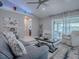 Bright and airy living room with large windows, neutral tones, and stylish furnishings at 17563 Se 122Nd Ter, Summerfield, FL 34491