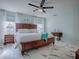Light and airy main bedroom features white tile floors, white bedding, and light blue walls at 17563 Se 122Nd Ter, Summerfield, FL 34491