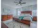 Spacious main bedroom with a dark wood bedroom suite, white bedding, and white curtains at 17563 Se 122Nd Ter, Summerfield, FL 34491