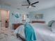 Bright main bedroom with an ensuite bathroom featuring a white tile floor and light blue walls at 17563 Se 122Nd Ter, Summerfield, FL 34491