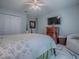 Comfortable bedroom featuring a large TV, dresser, and walk-in closet for ample storage and entertainment at 17563 Se 122Nd Ter, Summerfield, FL 34491