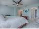 This bedroom features a ceiling fan, white marble tile floors, and pale blue walls at 17563 Se 122Nd Ter, Summerfield, FL 34491