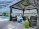 Covered patio with comfortable seating, fire table, and relaxing views of the pool at 17563 Se 122Nd Ter, Summerfield, FL 34491