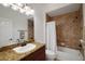 Bathroom featuring a vanity with granite countertop and a tiled shower over tub at 1828 Hollow Branch Way, The Villages, FL 32162
