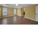 Bright bedroom featuring wood floors, large windows with shutters, and a ceiling fan at 1828 Hollow Branch Way, The Villages, FL 32162