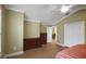 Spacious bedroom with wood-look floors and a view into the hall and dining area at 1828 Hollow Branch Way, The Villages, FL 32162