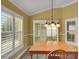 Dining area showing bright sunny windows with shutter shades and vaulted ceilings at 1828 Hollow Branch Way, The Villages, FL 32162