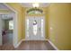 Bright foyer featuring a decorative glass door, and adjacent hardwood style flooring at 1828 Hollow Branch Way, The Villages, FL 32162