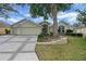Charming single-story home featuring a well-manicured lawn and inviting curb appeal at 1828 Hollow Branch Way, The Villages, FL 32162