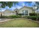 Lovely home showcasing manicured landscaping, a neutral color palette, and architectural details at 1828 Hollow Branch Way, The Villages, FL 32162