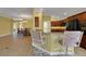 Open floor plan featuring kitchen with breakfast bar and dining area with wood floors throughout at 1828 Hollow Branch Way, The Villages, FL 32162