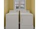 Clean laundry room with washer and dryer under a window at 1828 Hollow Branch Way, The Villages, FL 32162