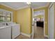 Convenient laundry room with tile floors, a large window, and a washer and dryer hook up at 1828 Hollow Branch Way, The Villages, FL 32162