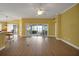 Spacious living room with hardwood floors, and glass sliding door to the outdoor patio at 1828 Hollow Branch Way, The Villages, FL 32162
