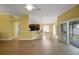 Bright open concept living space, seamlessly connecting the living room, dining area, and kitchen at 1828 Hollow Branch Way, The Villages, FL 32162