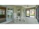 Comfortable screened-in patio with rocking chairs is perfect for relaxing and enjoying the outdoors at 1828 Hollow Branch Way, The Villages, FL 32162