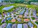 Aerial view of the community showcasing the neighborhood and its proximity to the golf course and a pond at 2044 Larkwood Ct, The Villages, FL 32162