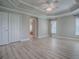 Inviting bedroom featuring a decorative tray ceiling, neutral walls, and an ensuite bathroom at 2044 Larkwood Ct, The Villages, FL 32162