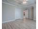 Bedroom featuring light gray walls, light wood-look flooring, and a double closet at 2044 Larkwood Ct, The Villages, FL 32162