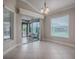 Bright dining area with tile floors, sliding glass doors to the patio, and a view of the backyard at 2044 Larkwood Ct, The Villages, FL 32162