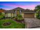 This home has beautiful flowerbeds, a large yard, a paver driveway, and a spacious two-car garage at 2044 Larkwood Ct, The Villages, FL 32162