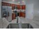 Modern kitchen with stainless steel appliances, ample cabinet space, and granite countertops at 2044 Larkwood Ct, The Villages, FL 32162