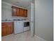 Laundry room with washer, dryer, granite countertop, and wooden cabinets at 2044 Larkwood Ct, The Villages, FL 32162