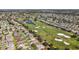 Aerial view shows a golf course community, featuring homes, a pond, and scenic views at 2096 Callaway Dr, The Villages, FL 32162