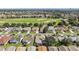 Aerial view of houses on a street, showcasing proximity to a golf course and a well-maintained community at 2096 Callaway Dr, The Villages, FL 32162