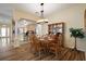 Charming dining room features wood floors, stylish lighting, and elegant dining set at 2096 Callaway Dr, The Villages, FL 32162