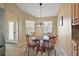 Cozy dining room features a glass table and natural light from two large windows at 2096 Callaway Dr, The Villages, FL 32162