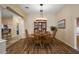 Elegant dining room with wood floors, chandelier lighting, and seamless flow to other living areas at 2096 Callaway Dr, The Villages, FL 32162