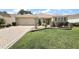 Home featuring a paver driveway, an attached two-car garage, and manicured landscaping in the front yard at 2096 Callaway Dr, The Villages, FL 32162