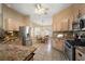 Spacious kitchen with stainless steel appliances, granite countertops and adjacent dining area at 2096 Callaway Dr, The Villages, FL 32162