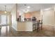 Open concept kitchen with breakfast bar, granite counters, and stainless steel appliances at 2096 Callaway Dr, The Villages, FL 32162