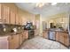 Well-equipped kitchen with light wood cabinets, stainless steel appliances, and granite countertops at 2096 Callaway Dr, The Villages, FL 32162