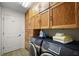 Functional laundry room featuring ample cabinet space and modern washer and dryer units at 2096 Callaway Dr, The Villages, FL 32162